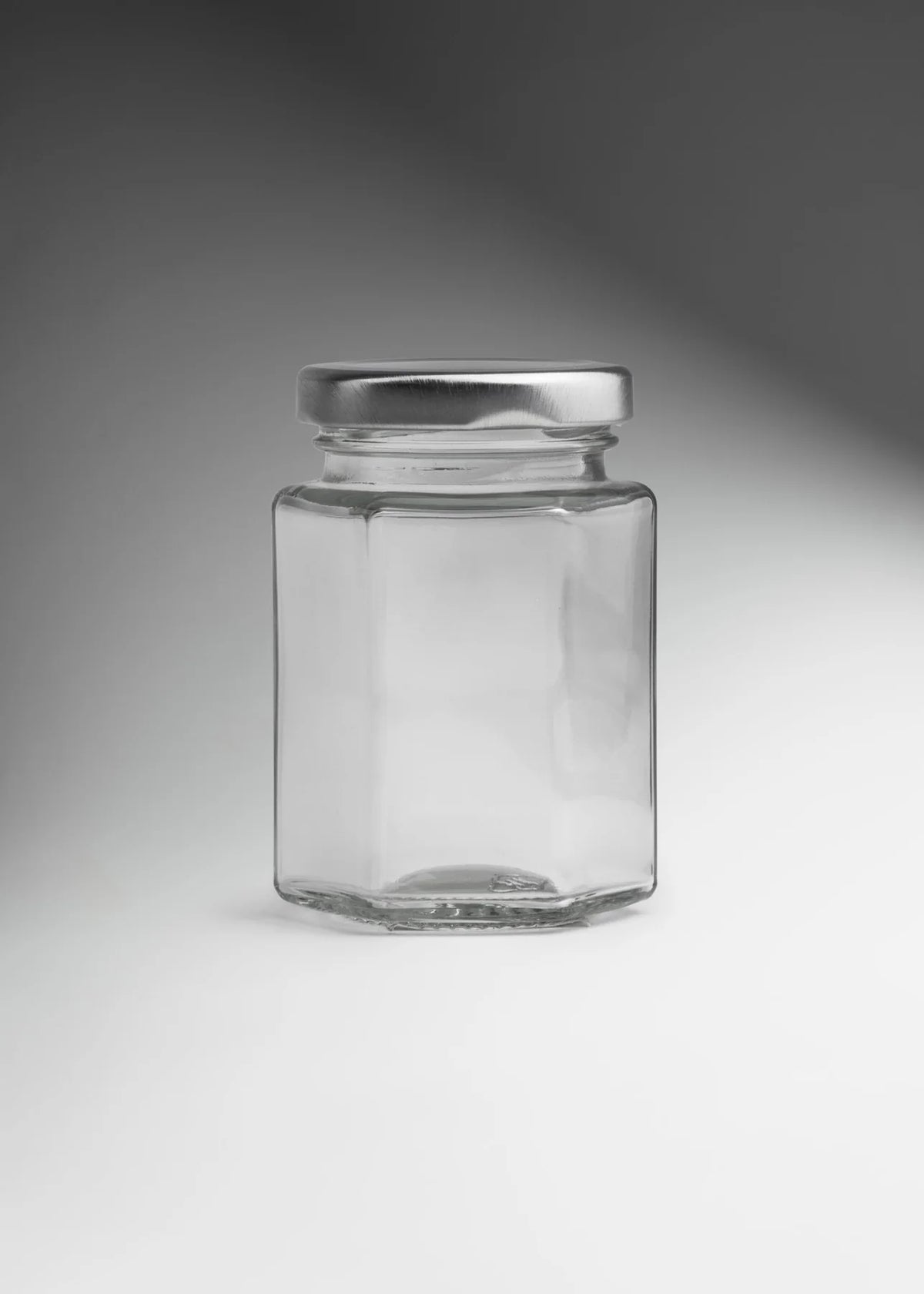 FRASCO VIDRIO HEXAGONAL TAPA PLATA 100ML