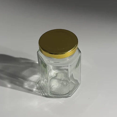 FRASCO VIDRIO HEXAGONAL TAPA DORADA 100ML