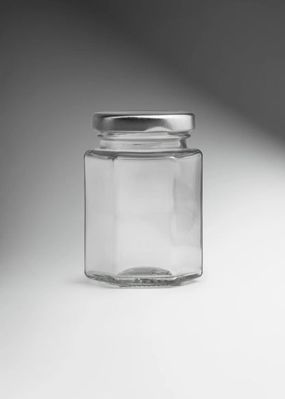 FRASCO VIDRIO HEXAGONAL TAPA PLATA 100ML