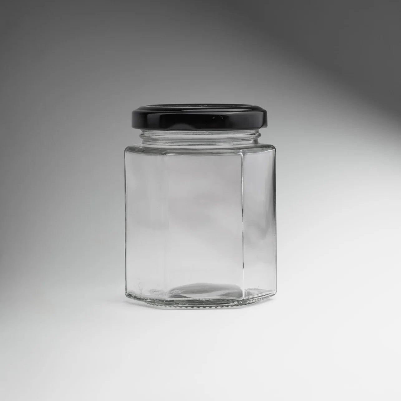 FRASCO VIDRIO HEXAGONAL TAPA NEGRA 100ML